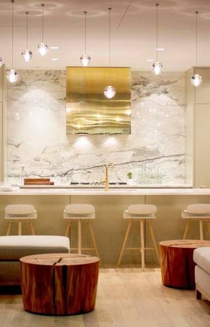 Gold Range Hood With Swirling Texture Adds a Warm Focal Point