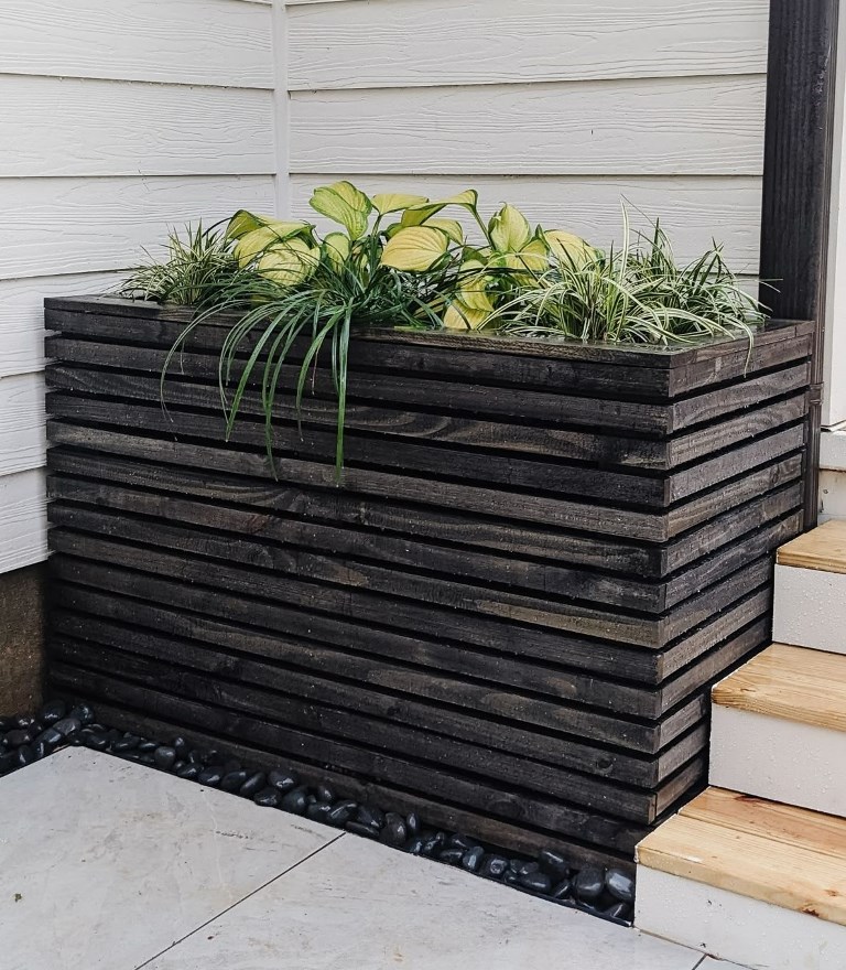 Dark Stained Wood Planter With Layered Greenery