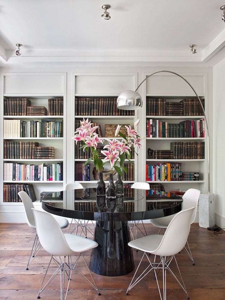 Glossy Black Pedestal Table Anchors White Chairs