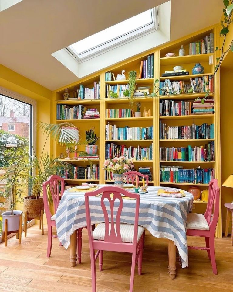 Bright Yellow Built-In Shelving Frames a Dining Area