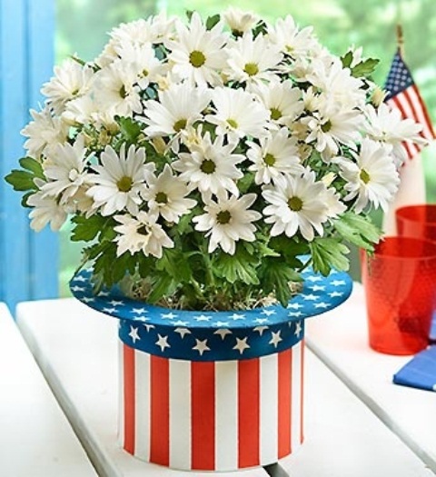 Uncle Sam Hat Planter Holds a Bouquet of White Daisies
