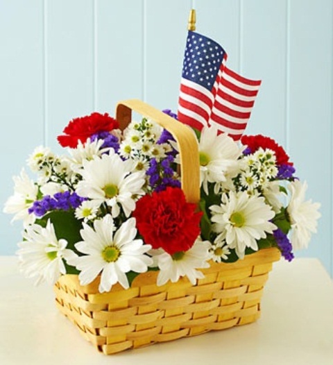 Woven Basket Filled With Red, White, and Blue Blooms and Flags