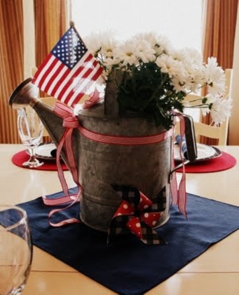 Galvanized Watering Can Holds White Blooms and a Flag