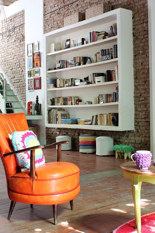 Floating White Shelves Break Up a Brick Wall