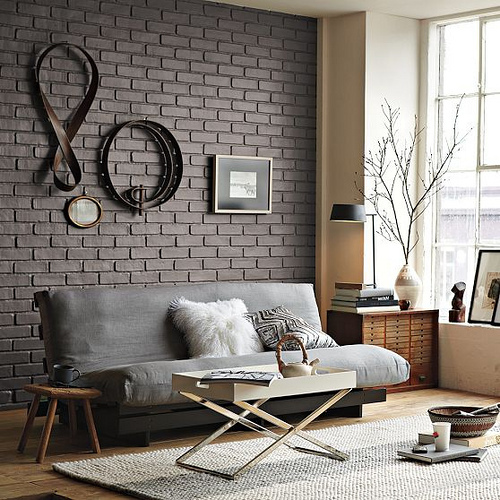 Dark Brick Walls With Sculptural Wall Art