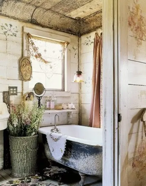 Woven Basket With Tall Greenery Next to Clawfoot Tub