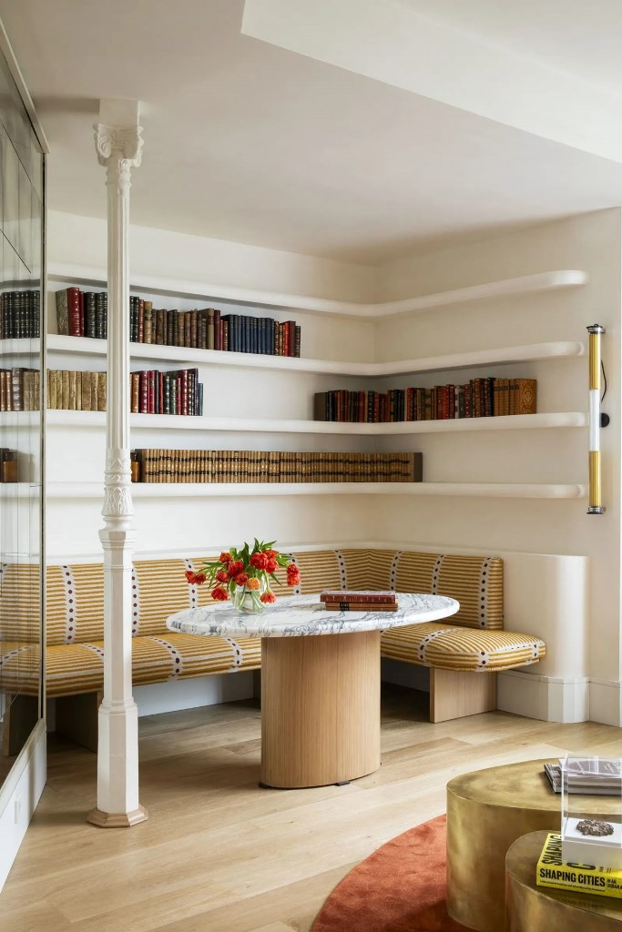 Curved White Shelves Wrap Around a Cozy Dining Nook