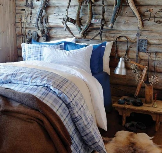 Vintage Horse Tack Creates Rustic Wall Art Above the Bed