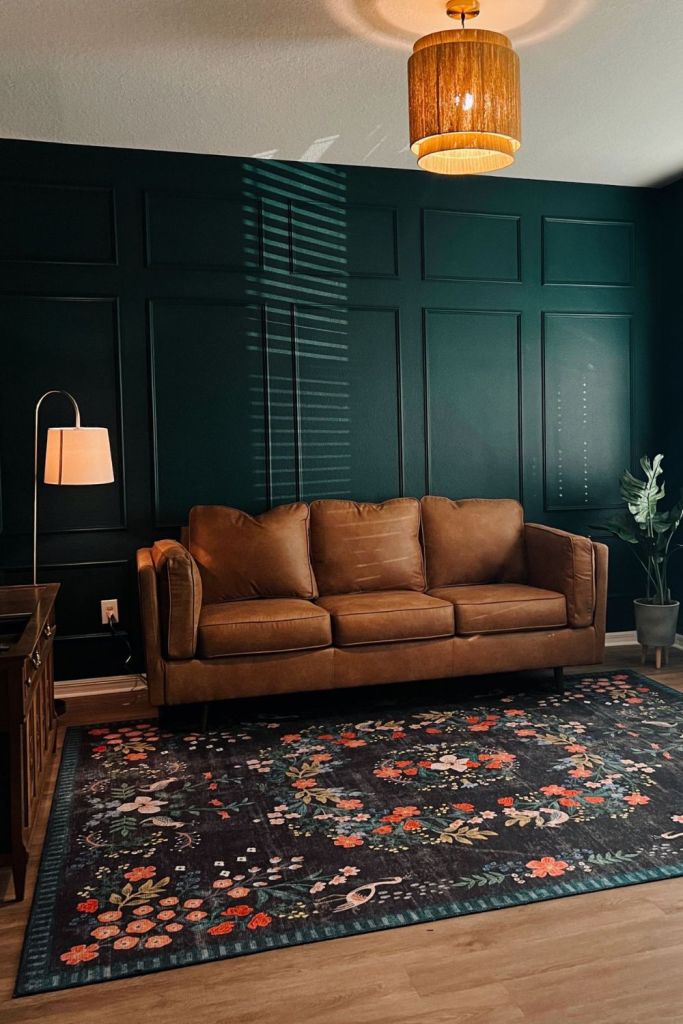 Dark Paneled Walls Create a Dramatic Backdrop for a Brown Sofa