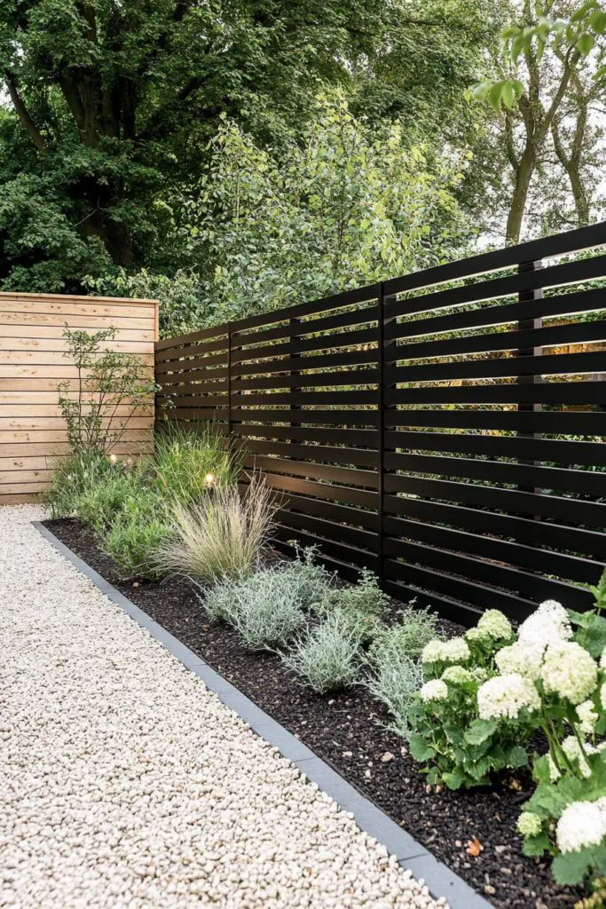 Dark Slatted Fence With Contrasting Low-Growing Greenery