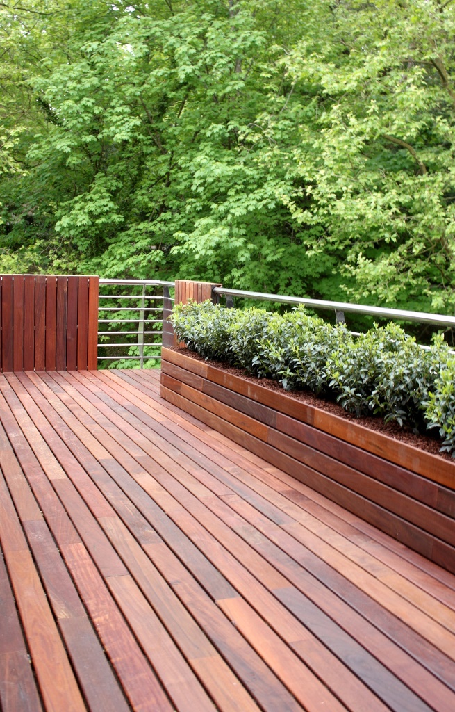 Long Wooden Planter Box With Dense Greenery