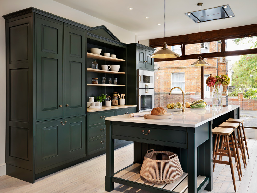 Dark Green Cabinetry Frames Open Shelving for Display