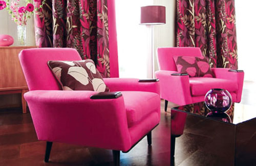 Pink Armchairs with Leaf-Patterned Pillows Make a Bold Statement