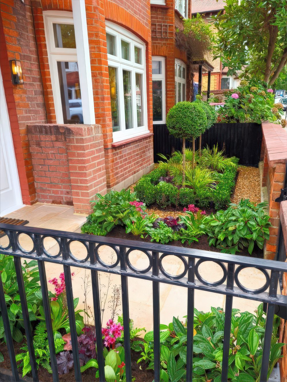 Topiary Trees Add Architectural Interest to a Compact Garden Bed