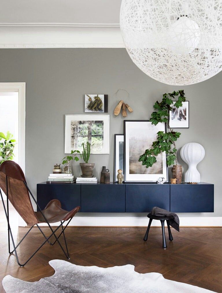 Floating Dark Blue Cabinet Adds Sleek Storage Below Wall Art