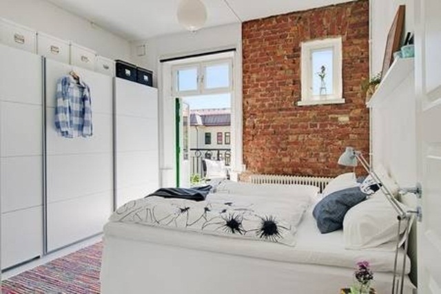 White Wardrobes Create a Seamless Storage Wall