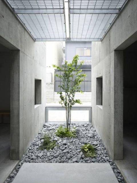 Modern Courtyard with Crushed Stone and Minimalist Greenery