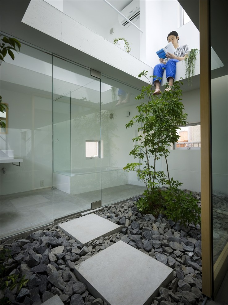 Square Concrete Pavers Create a Path Through Dark Gravel