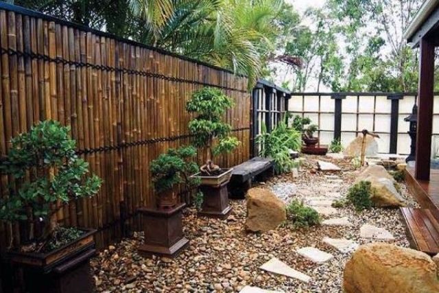 Bonsai Trees on Dark Pedestals Add Height to Gravel Gardens