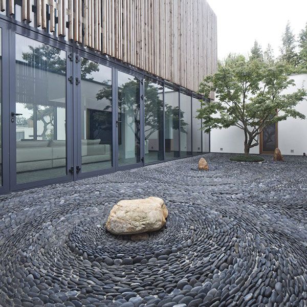 Pebble Garden Raked into Spirals Around Boulders