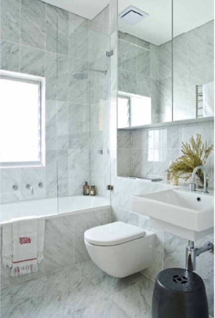 Dark Stool Adds Contrast Next to White Sink