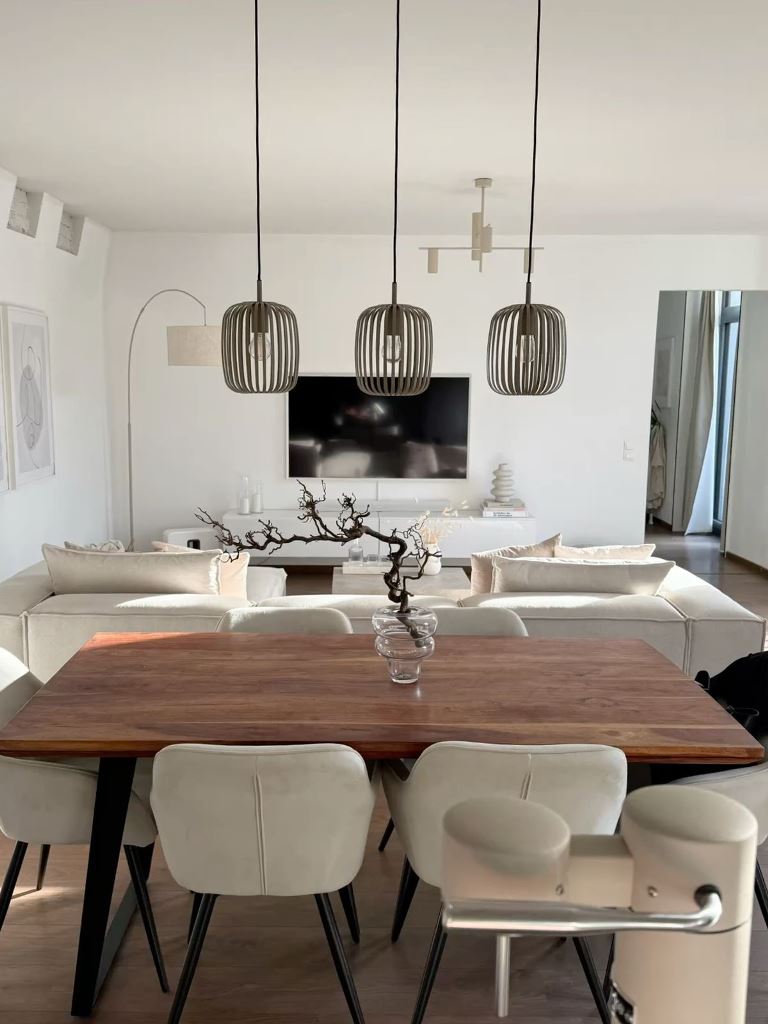 Three Slatted Pendant Lights Define Dining Area