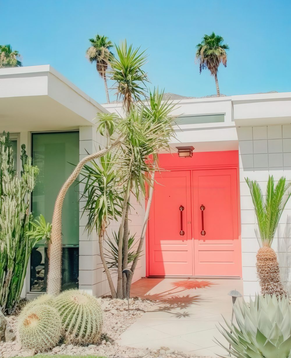 Bold Coral Doors Create a Welcoming Focal Point