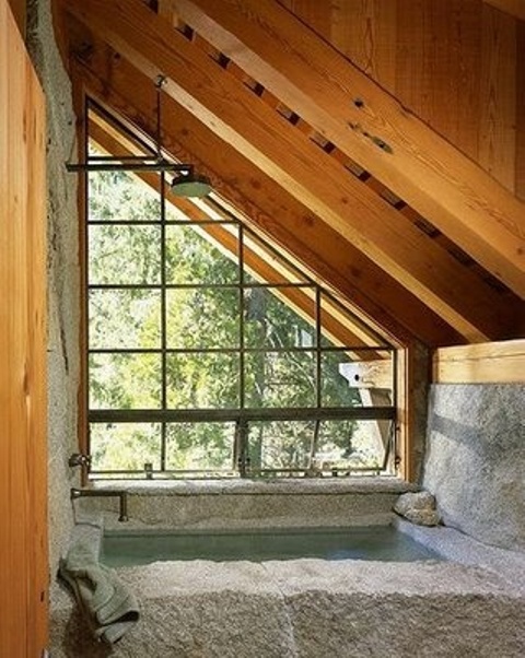 Stone Bathtub Embraces Natural Landscape Through Window