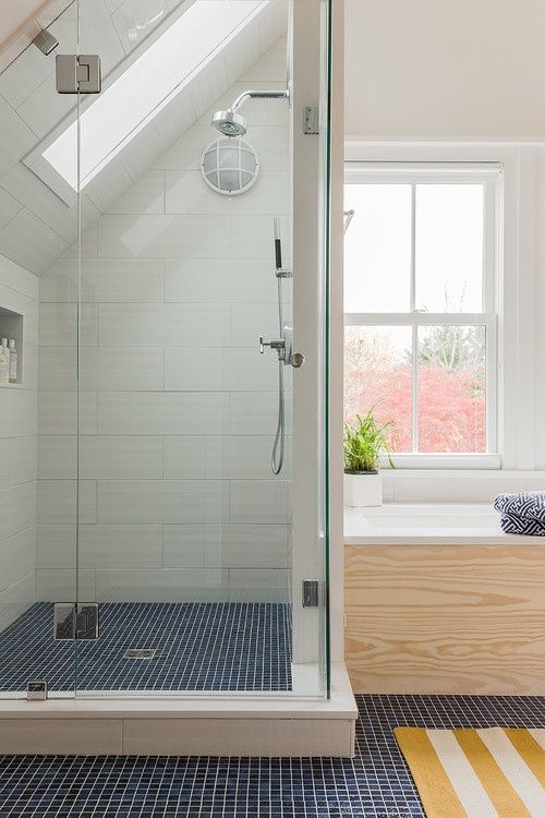Dark Blue Mosaic Floor Contrasts with White Shower
