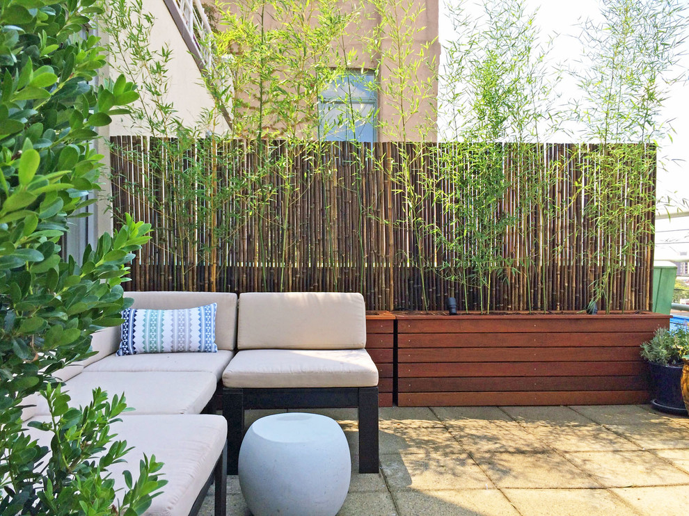 Bamboo Panels Offer Natural Privacy Behind a Raised Bed