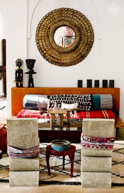 Ornate Round Mirror Frames a Collection of Global Decor