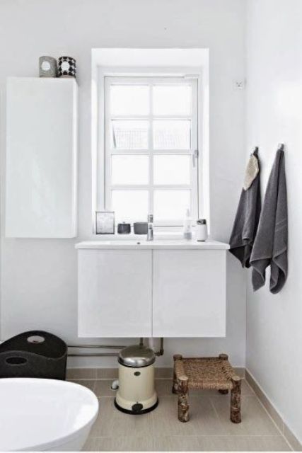 Small Woven Stool Adds Natural Texture Beside the Sink