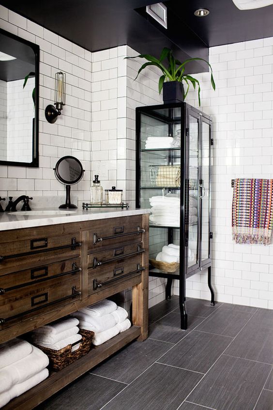 Glass-Fronted Cabinet Adds Visible Storage for Folded Towels