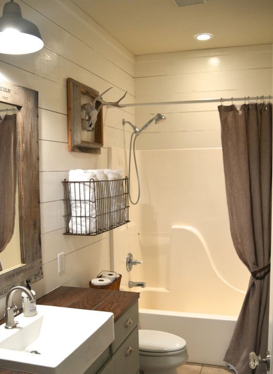 Wire Basket Keeps Towels Neatly Stacked Near Shower