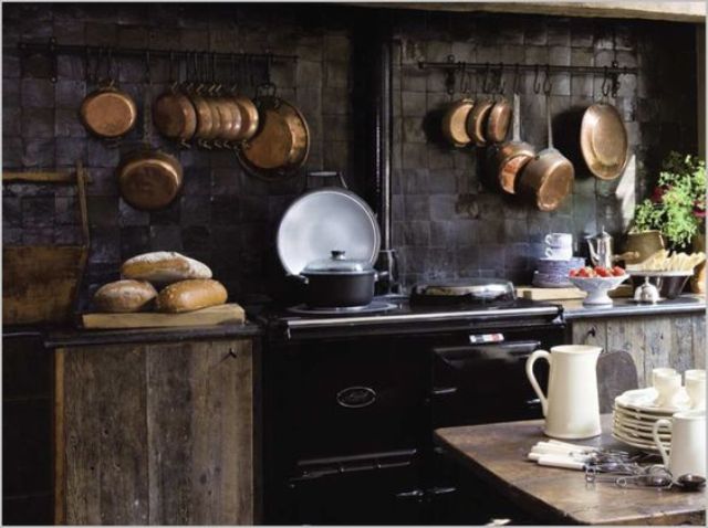 Copper Pots Hung on Wall Rails Add Warmth and Shine