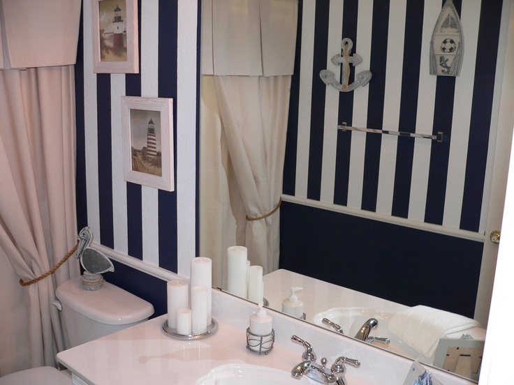 Framed Lighthouse Art Adds Coastal Scenes Above Toilet