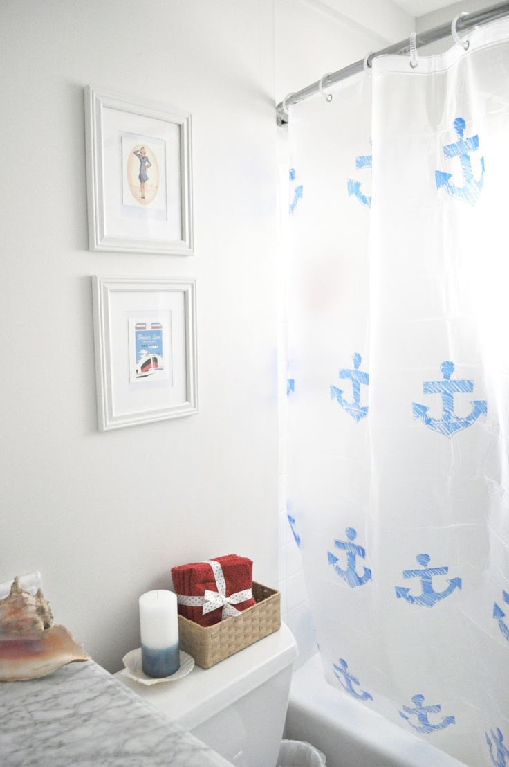 Framed Nautical Art Adds Personality Above the Toilet Tank