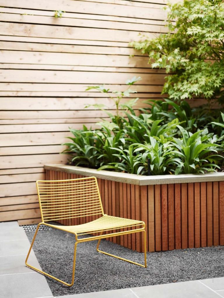 Yellow Wire Chair Adds Pop of Color to Wood Garden