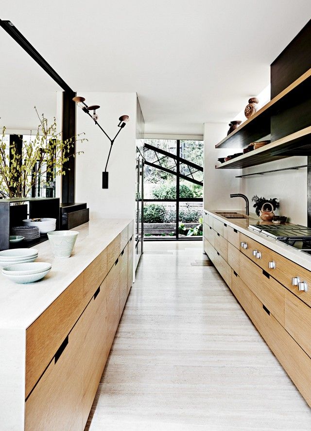 Black Wall Sconce Adds Sculptural Interest Above Counter