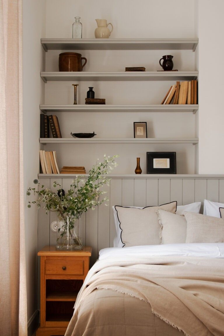 Open Shelving Above Bed Displays Books and Decor
