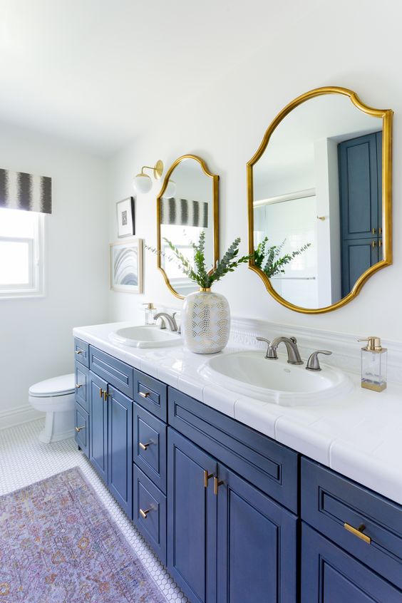 Scalloped Gold Mirrors Above Blue Vanity