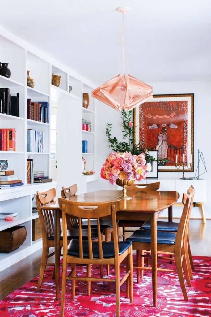 Oval Wood Table Anchored by a Bold Geometric Rug