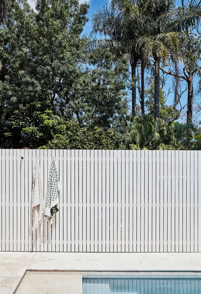 Hooks on White Slatted Fence for Hanging Towels