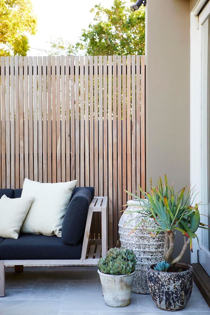 Contrast a Natural Wood Fence with Textured Ceramic Pots
